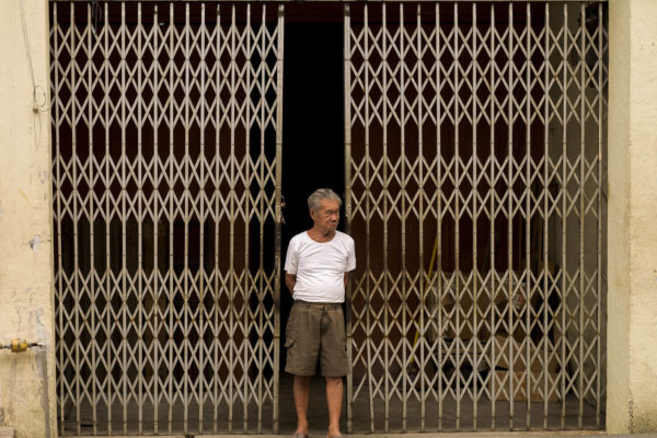 Man In Front Of A Closed Shop, Malacca, Malaysia